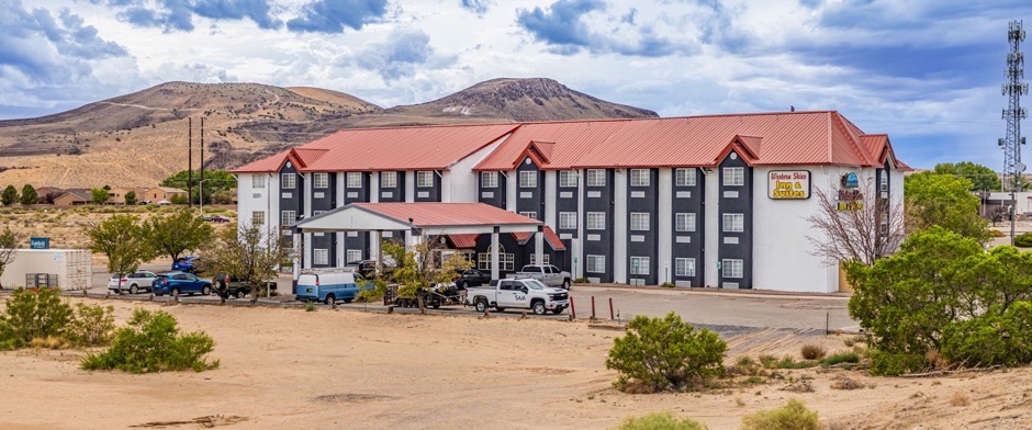 Western Skies Inn & Suites with the New Mexico mountains in the background