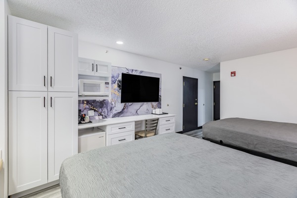 Two queen room storage and television
